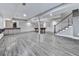 Open concept basement features a pool table, wet bar, stairway, and wood-look flooring at 2347 Univeter Rd, Canton, GA 30115