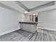 Finished basement with gray vinyl plank floors and a bar area with light wood cabinets at 2347 Univeter Rd, Canton, GA 30115