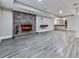 Basement with gray vinyl plank floors and a brick fireplace with a flat screen television at 2347 Univeter Rd, Canton, GA 30115
