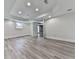 Open basement features light gray walls, recessed lighting, wood-look floors, and access to outside at 2347 Univeter Rd, Canton, GA 30115