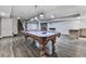Open basement featuring a pool table, wet bar, fireplace, and vinyl plank flooring at 2347 Univeter Rd, Canton, GA 30115