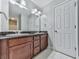 Bathroom with double sink vanity, granite countertop and white ceramic tile floor at 2347 Univeter Rd, Canton, GA 30115