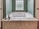 Bathroom features a large soaking tub with tile surround at 2347 Univeter Rd, Canton, GA 30115