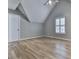 Bedroom features a large window with plantation shutters and hardwood floors at 2347 Univeter Rd, Canton, GA 30115