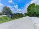 Scenic driveway leading to a charming home with a dark wooden fence at 2347 Univeter Rd, Canton, GA 30115