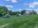 Scenic view of an expansive lawn featuring mature trees, complemented by a charming fence that defines the property's boundary at 2347 Univeter Rd, Canton, GA 30115