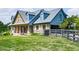 Charming exterior of a blue home with brick and wood accents, and a fenced yard at 2347 Univeter Rd, Canton, GA 30115