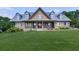 Spacious home with brick facade, covered porch, and lush green lawn at 2347 Univeter Rd, Canton, GA 30115
