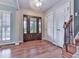 Elegant foyer showcasing a decorative glass front door, hardwood floors, and staircase leading to the upper level at 2347 Univeter Rd, Canton, GA 30115