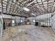Large garage interior with exposed beams, ample workspace, and storage shelves at 2347 Univeter Rd, Canton, GA 30115
