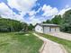 Spacious two-car detached garage with a playground set on a generous lawn at 2347 Univeter Rd, Canton, GA 30115