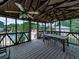 A beautifully screened-in gazebo is ideal for dining al fresco overlooking the pool with ceiling fans for added comfort at 2347 Univeter Rd, Canton, GA 30115