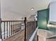 A light-filled hallway boasts hardwood floors and decorative wrought iron railings at 2347 Univeter Rd, Canton, GA 30115