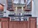 A kitchen with stainless steel professional-grade appliances, granite countertops, and custom wood cabinets at 2347 Univeter Rd, Canton, GA 30115