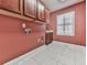 Laundry room with cabinets and tile flooring at 2347 Univeter Rd, Canton, GA 30115