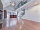 Open-concept living room with a stone fireplace, vaulted ceiling, hardwood floors, and access to the second level at 2347 Univeter Rd, Canton, GA 30115