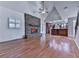 Spacious living room with vaulted ceilings, a stone fireplace, hardwood floors, and a connection to the kitchen at 2347 Univeter Rd, Canton, GA 30115