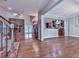 Open-concept living space featuring a stone fireplace, hardwood floors, and seamless flow to the kitchen area at 2347 Univeter Rd, Canton, GA 30115