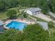 Aerial view of home's pool area, featuring an in-ground pool, flagstone patio, gazebo, and play area at 2347 Univeter Rd, Canton, GA 30115