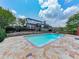 The sparkling pool is surrounded by a stone patio, offering a serene escape with ample space for lounging and outdoor enjoyment at 2347 Univeter Rd, Canton, GA 30115