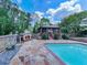 This inviting poolside area offers a relaxing outdoor retreat, complete with a charming gazebo and a cozy stone fireplace at 2347 Univeter Rd, Canton, GA 30115