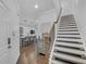 Open-concept entryway showcases hardwood floors, a staircase, and a view into the modern kitchen and living area at 360 Niles Ct, Marietta, GA 30060