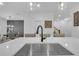 Large quartz kitchen island with modern faucet, view into living room, and natural light illuminating the space at 360 Niles Ct, Marietta, GA 30060