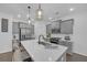 Stylish kitchen with grey cabinetry, stainless steel appliances, quartz countertops, and elegant pendant lighting at 360 Niles Ct, Marietta, GA 30060