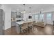 Modern kitchen featuring grey cabinets, a white quartz island, stainless steel appliances, and an adjacent living area at 360 Niles Ct, Marietta, GA 30060