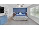 Spacious main bedroom with a blue accent wall, plush bedding, and a large window for natural light at 360 Niles Ct, Marietta, GA 30060