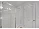 Tiled walk-in shower with glass door next to a white linen closet at 360 Niles Ct, Marietta, GA 30060