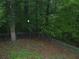 Lush backyard surrounded by trees and a chain link fence, great for outdoor activities at 553 Old Mill Ct, Norcross, GA 30093