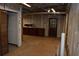 A basement space with exposed utilities, unfinished walls and wooden cabinets and door at 553 Old Mill Ct, Norcross, GA 30093