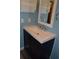Modern bathroom vanity with sleek design and ample storage complements the serene blue walls at 553 Old Mill Ct, Norcross, GA 30093