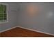 A bright, empty bedroom with hardwood floors, fresh paint, and a large window at 553 Old Mill Ct, Norcross, GA 30093