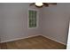 This is a carpeted bedroom with natural light, offering a simple and comfortable living space at 553 Old Mill Ct, Norcross, GA 30093