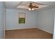 Serene bedroom with neutral carpet, ceiling fan, and window providing natural light at 553 Old Mill Ct, Norcross, GA 30093