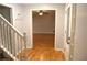 The light filled foyer offers a view into the living room, a coat rack, and hardwood flooring at 553 Old Mill Ct, Norcross, GA 30093