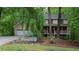 Charming two-story home with a well-maintained lawn, two car garage and landscaped flower beds in a wooded surrounding at 553 Old Mill Ct, Norcross, GA 30093