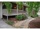 The front porch is framed by manicured landscaping, a stone pathway and a set of stairs at 553 Old Mill Ct, Norcross, GA 30093
