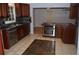Modern kitchen featuring stainless steel appliances, granite countertops and dark cabinets at 553 Old Mill Ct, Norcross, GA 30093