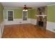 The inviting living room features hardwood floors, white wainscoting, and a charming stone fireplace at 553 Old Mill Ct, Norcross, GA 30093