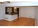 Open concept living room with a view into the kitchen, hardwood floors, and ample natural light at 553 Old Mill Ct, Norcross, GA 30093