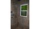 Contemporary shower with decorative tilework and convenient storage shelves, offering a spa-like retreat at 553 Old Mill Ct, Norcross, GA 30093
