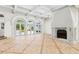 Spacious living room features tile flooring, coffered ceilings, a decorative fireplace and French doors to the backyard at 9355 Huntcliff Trce, Sandy Springs, GA 30350