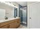 Bathroom with double sink vanity, and glass enclosed shower with blue tile at 1095 Tucker Ave # 503, Atlanta, GA 30310