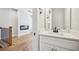 Powder room features white vanity and sink next to a living space at 1095 Tucker Ave # 503, Atlanta, GA 30310