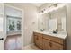 Bright bathroom features double vanity with undermount sinks and wood cabinets at 1095 Tucker Ave # 503, Atlanta, GA 30310