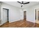 Spacious bedroom with hardwood floors, ceiling fan, and ensuite bathroom at 1095 Tucker Ave # 503, Atlanta, GA 30310