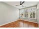 Bright bedroom with hardwood floors, ceiling fan and a large window at 1095 Tucker Ave # 503, Atlanta, GA 30310